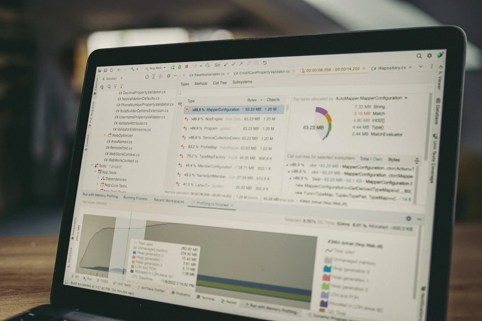 A laptop displaying software performance charts and measurements